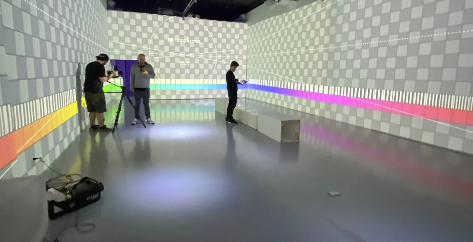 Music video pre-production: a crew testing projectors in an empty studio